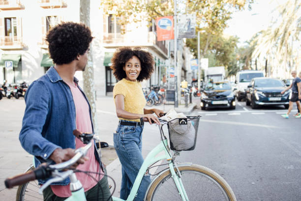 istock Happy Afro couple enjoying in Barcelona on bikes 1401823143