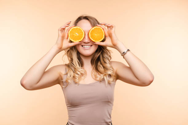 istock Cheerful young blonde posing with fresh oranges 1401823216