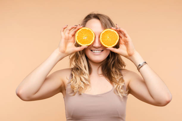istock Cheerful young blonde posing with fresh oranges 1401823217