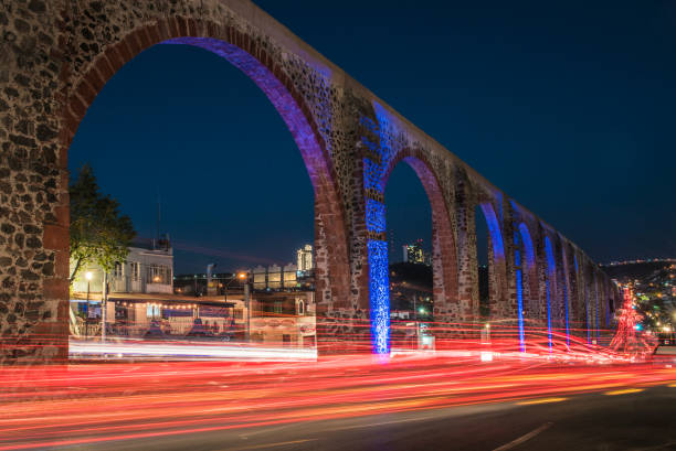 pink stone aqueduct of Querétaro, Mexico Santiago de Querétaro is known for its well-preserved Spanish colonial architecture, and among its architectural gems is an amazing pink stone aqueduct that crosses part of the city. queretaro city stock pictures, royalty-free photos & images
