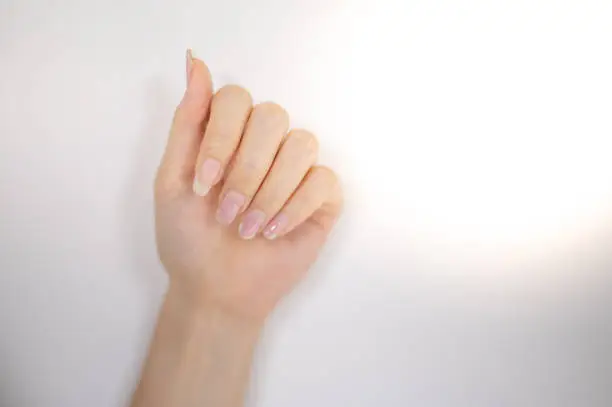Female nail weakness damage from gel polish coating, Fingernail manicure.