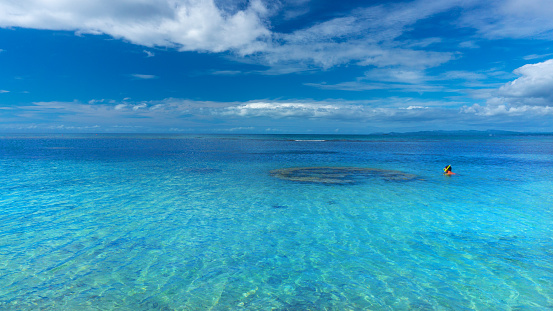 one person snorkeling in blue water