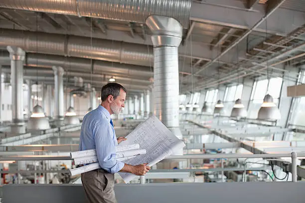 Photo of Architect viewing blueprints