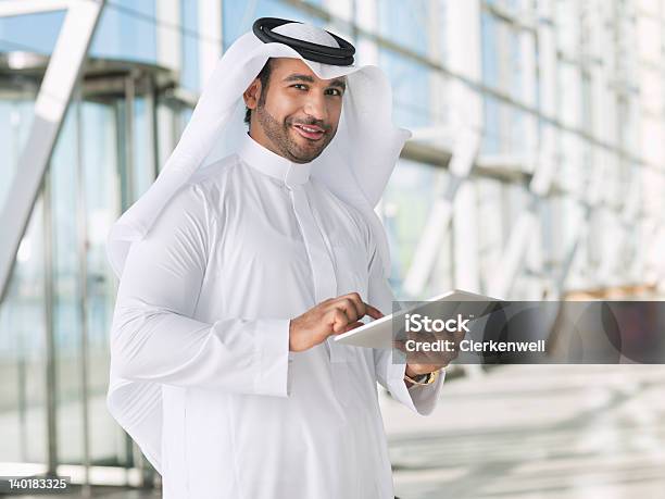 Portrait Of Smiling Businessman In Kaffiyeh Using Digital Tablet Stock Photo - Download Image Now
