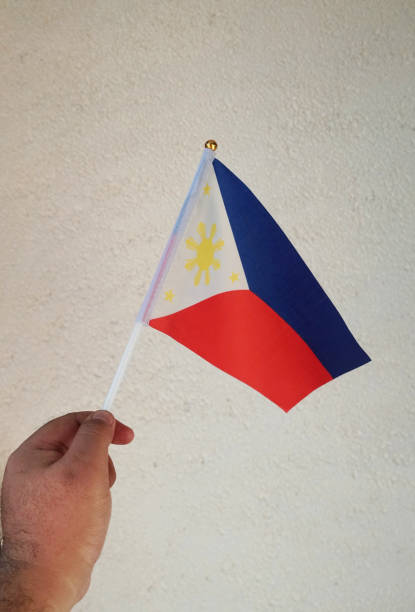 istock A hand waves a Philippine Flaglet on a white background 1401834998