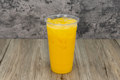 Tasty mango milkshake in a tall cup and ice cold for that thirsty appetite.