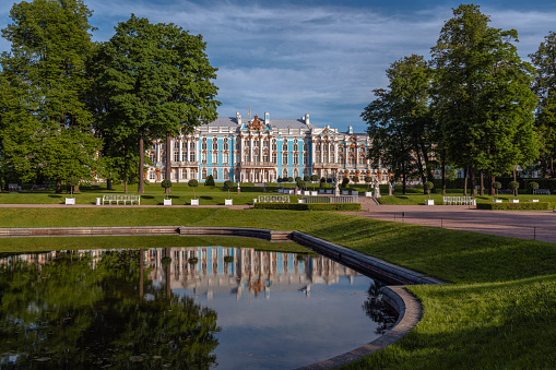 Catherine Palace with a reflection in the Mirror Pond of the Catherine Park in Tsarskoye Selo on a sunny summer day. Pushkin, St. Petersburg. Russia