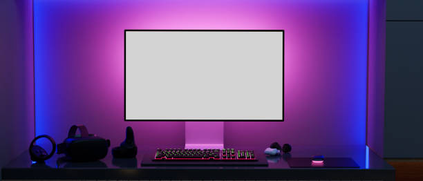Modern gamer computer desk setup with RGB lights on the background, PC computer Modern gamer computer desk setup with RGB lights on the background, Modern PC computer white screen mockup, gaming keyboard, VR glasses and stuff on the table. 3d rendering, 3d illustration pc computer monitor stock pictures, royalty-free photos & images