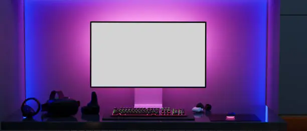 Modern gamer computer desk setup with RGB lights on the background, Modern PC computer white screen mockup, gaming keyboard, VR glasses and stuff on the table. 3d rendering, 3d illustration