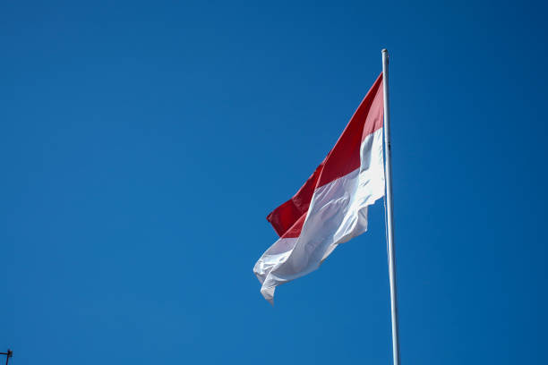 Indonesian flag with blue sky background.