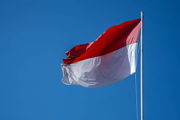 istock Indonesian flag with blue sky background. 1401852299