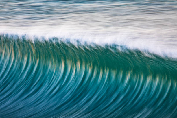 istock Close up of clean ocean wave peaking during sunrise at the beach 1401856761