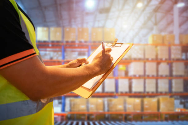 istock Workers Holding Clipboard is Checking Cargo Boxes on Tall Shelf. Storage Warehouse Suppliers Inventory Management. Supply Chain. Shipment Goods. Shipping Warehouse Logistics. 1401856953