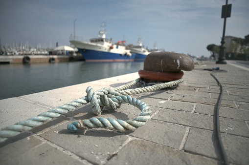 Port in Italy with a tied rope of a boat