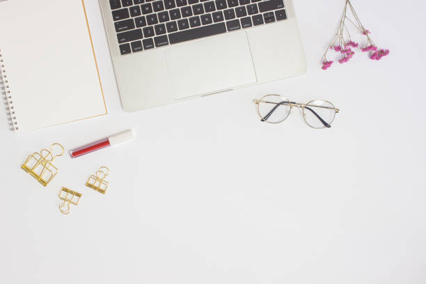 istock Working space with keyboard, glasses, flowers and lips over the white background. 1401861003