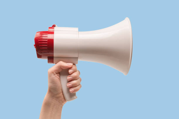 istock Megaphone in woman hands on a white background. 1401861466