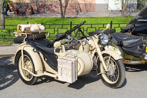 Ekaterinburg, Russia - May 9, 2012: White Soviet classic motorcycle IMZ M-72 takes part in the retro car show of the Victory Day.
