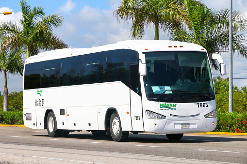 Quintana Roo, Mexico - May 16, 2017: White touristic coach bus Irizar at an intercity road.