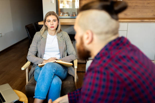 istock Female psychologist talking to young mam during session. 1401865997