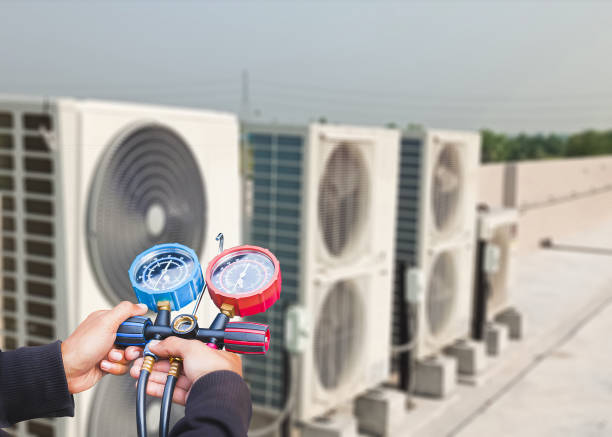 Technician checking air conditioning operation, detecting refrigerant leaks. stock photo