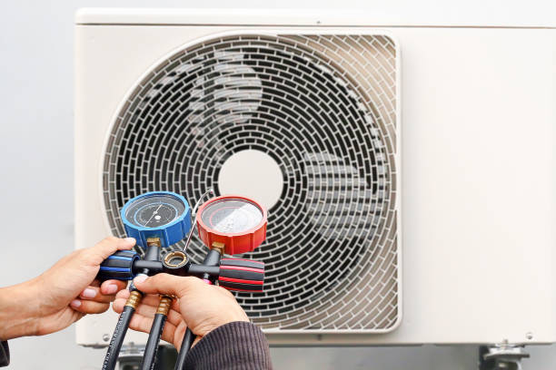Technician checking the operation of the air conditioner stock photo