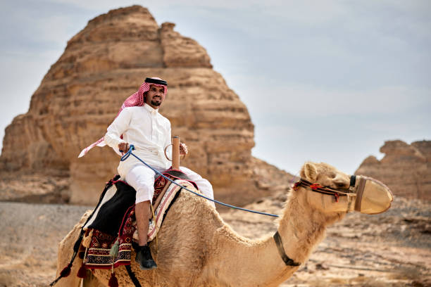 istock Late 20s Saudi man riding camel in desert environment 1401869352