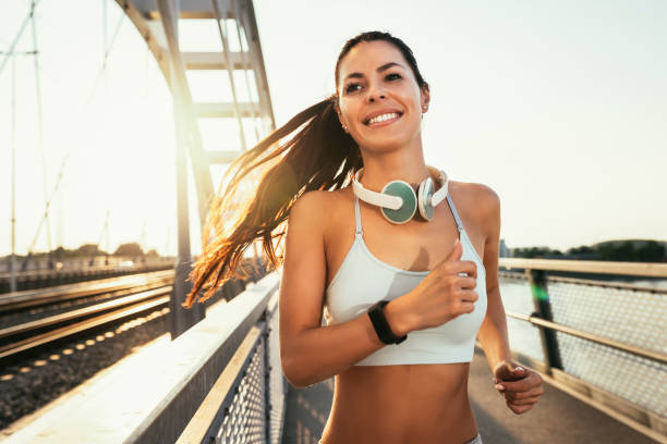istock Female runner jogging in the city on the bridge 1401870366