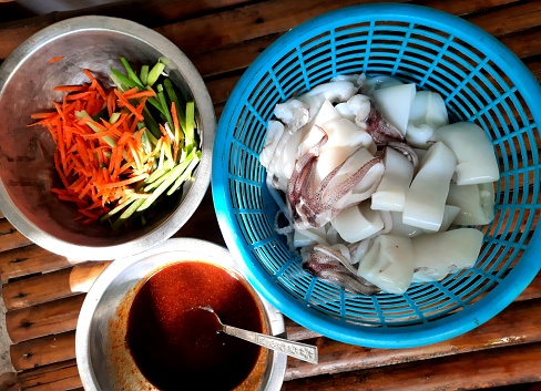 Preparing ingredients to cook Stir fried Squid with carrot in Chili paste - food preparation.