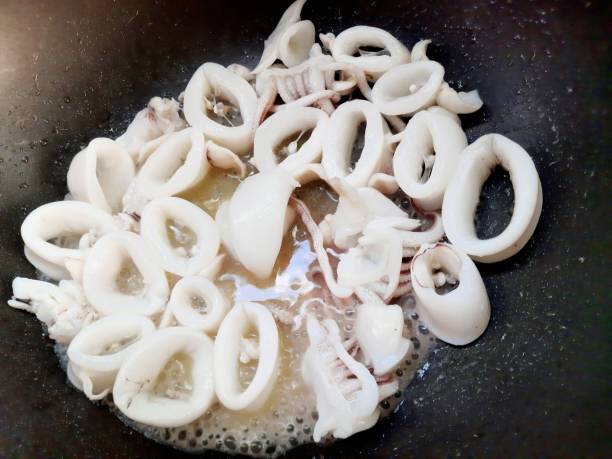istock Squid in cooking pan - food preparation. 1401875728