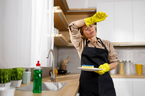 tired of household chores woman washes dishes in the kitchen - stereotypical housewife depression sadness women imagens e fotografias de stock