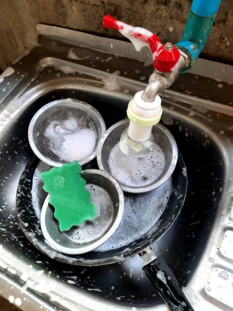 istock Washing Cooking utensils in kitchen sink after food preparation. 1401877285