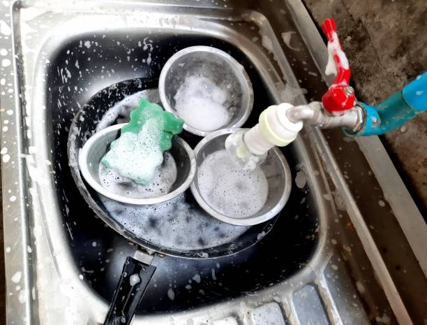 istock Washing Cooking utensils in kitchen sink after food preparation. 1401877286