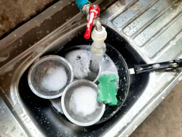 istock Washing Cooking utensils in kitchen sink after food preparation. 1401877376