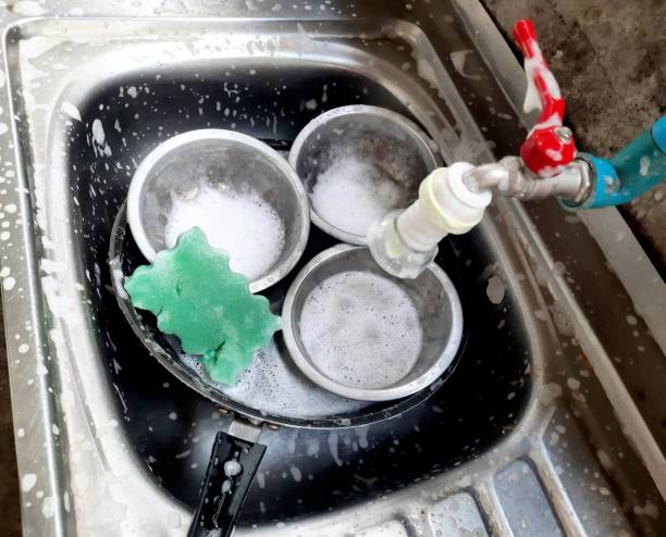 istock Washing Cooking utensils in kitchen sink after food preparation. 1401877378