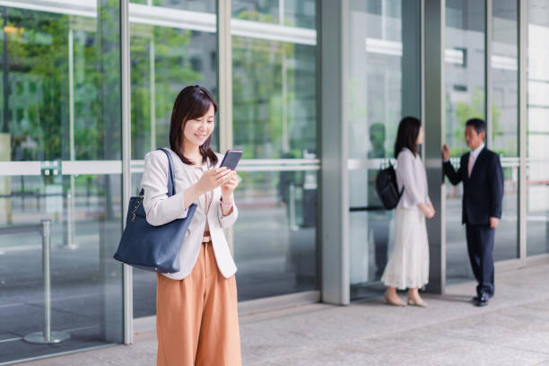 istock Businesswoman using a smartphone with a smile 1401877643