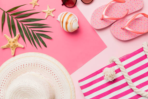 istock Beach accessories straw hat and seashell on colored table. Summer concept background 1401877795