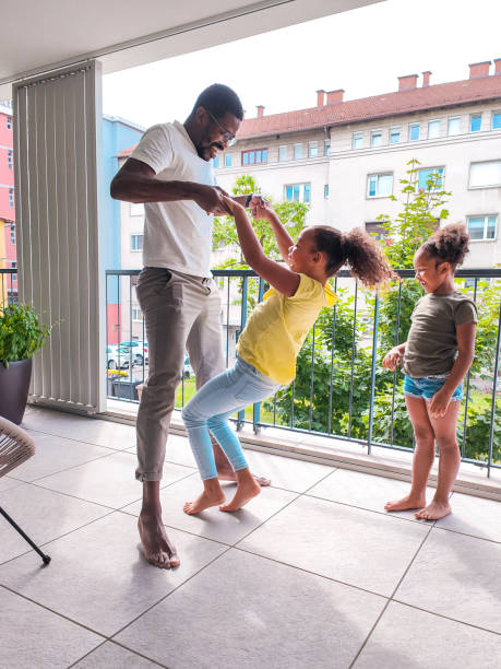 istock Mixed-Race Playful Girl Playing with Confident Father on the Balcony 1401879149