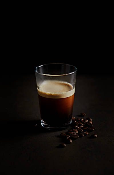 istock Glass of espresso coffee on dark stone background 1401879982