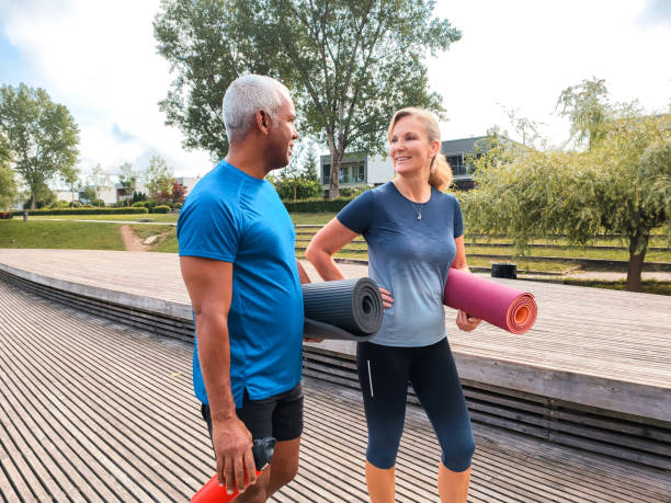 istock Active Mature Multiracial Couple Walking With Yoga Mats 1401881401