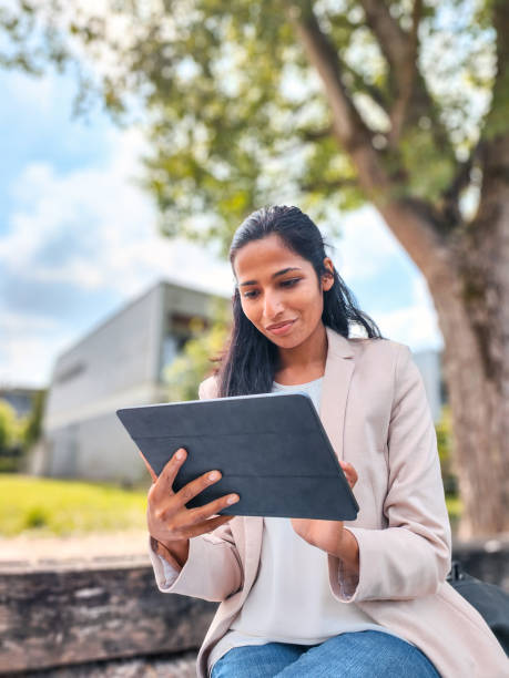 istock Young Indian Businesswoman Working Outdoors With A Digital Tablet 1401881724