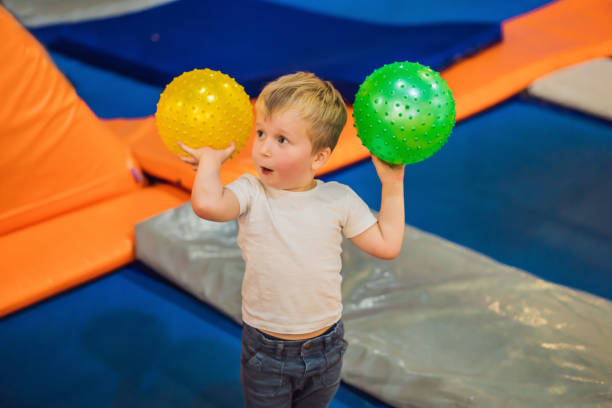 istock Little boy with a ball on trampolines 1401881892