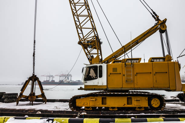 Excavating machine Liebherr on the dredge ship in sea port