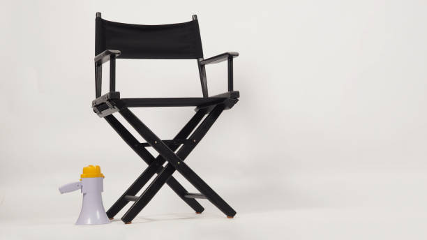 istock Black director chair and megaphone on white background. 1401887331