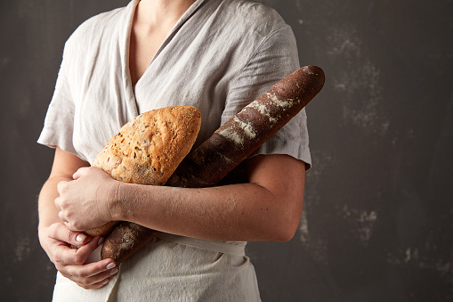 Woman holding a freshly baked organic bread