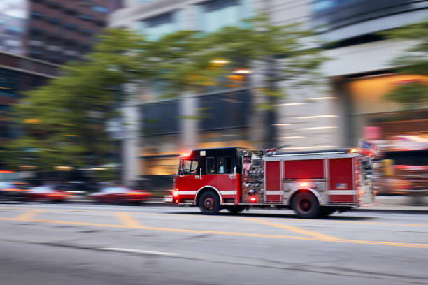 Fast moving fire engine on city street in blurred motion"n stock photo