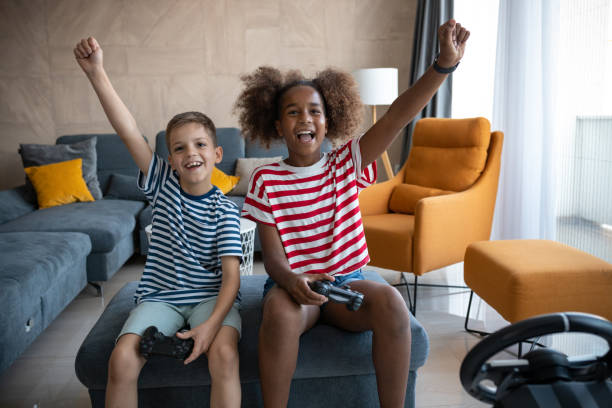 istock Two kids playing video games 1401889382