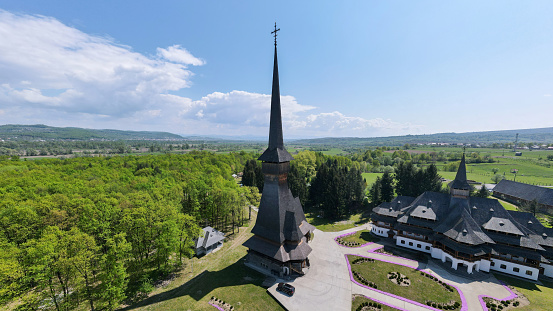 Aerial drone view of the Peri-Sapanta Monastery, Romania. Main church and other buildings, inner court. Forest around it