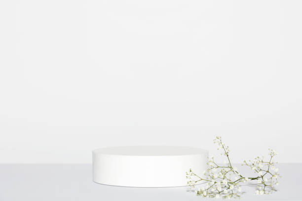 istock Abstract empty white podium and white flowers on grey background. Mock up stand for product presentation. 3D Render. Minimal concept. 1401890902