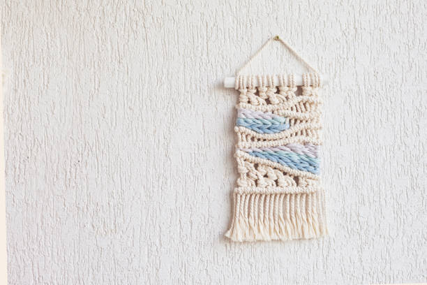 istock Handmade macrame. 100% cotton wall hanging decoration. Maritime theme.  Macrame braiding and cotton threads.  Female hobby.  ECO friendly modern knitting DIY natural decoration concept in the interior 1401890937