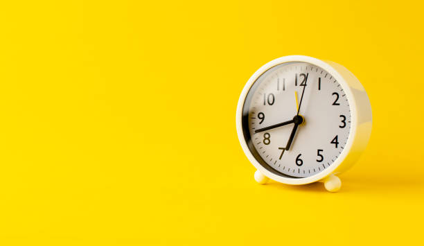 istock white alarm clock on a yellow background time concept with keywords working time 1401891441